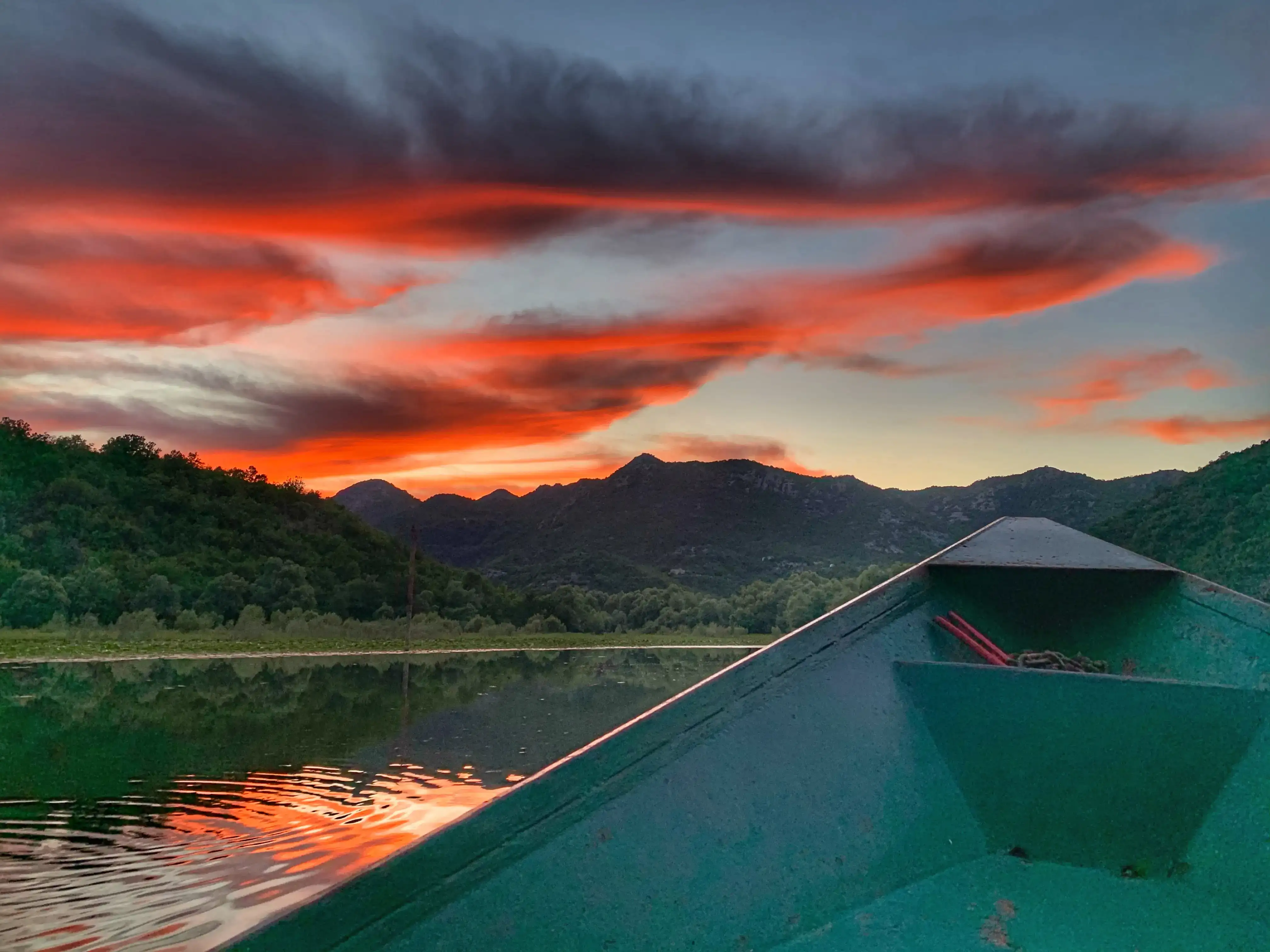 Golden sunset light on Skadar Lake with silhouetted mountains